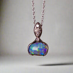 This exquisite pendant features a rare Australian Boulder Opal set in 18k white gold, expertly crafted to highlight the opal’s vibrant play of colors. Accented with natural diamonds, this statement piece that combines exceptional craftsmanship with the distinctive allure of genuine opal.