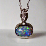 This exquisite pendant features a rare Australian Boulder Opal set in 18k white gold, expertly crafted to highlight the opal’s vibrant play of colors. Accented with natural diamonds, this statement piece that combines exceptional craftsmanship with the distinctive allure of genuine opal.