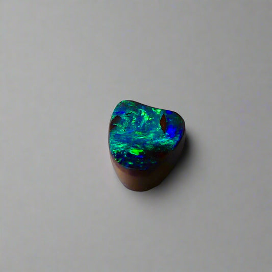 Experience the allure of this stunning 1.90ct Australian Boulder Opal, glowing with vivid green and blue hues. Its vibrant colors and natural brilliance make it an ideal centerpiece for a ring, offering a unique and elegant statement.
