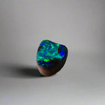 Experience the allure of this stunning 1.90ct Australian Boulder Opal, glowing with vivid green and blue hues. Its vibrant colors and natural brilliance make it an ideal centerpiece for a ring, offering a unique and elegant statement.
