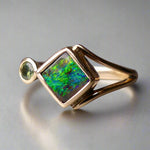 Discover the elegance of this unique 9k gold Australian Boulder Opal ring, beautifully paired with a stunning Australian sapphire. The vibrant opal’s natural patterns and the sapphire’s green blue hues create a captivating contrast, making this ring a true statement piece.