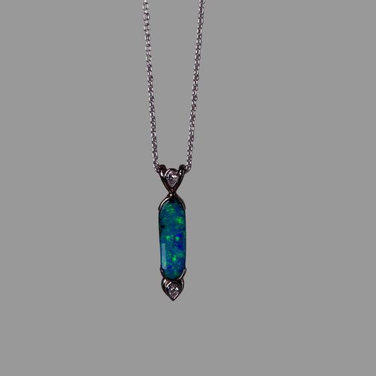 Necklace with a pendant featuring a blue opal stone on a dark gray background