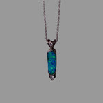 Opal pendant necklace on a gray background