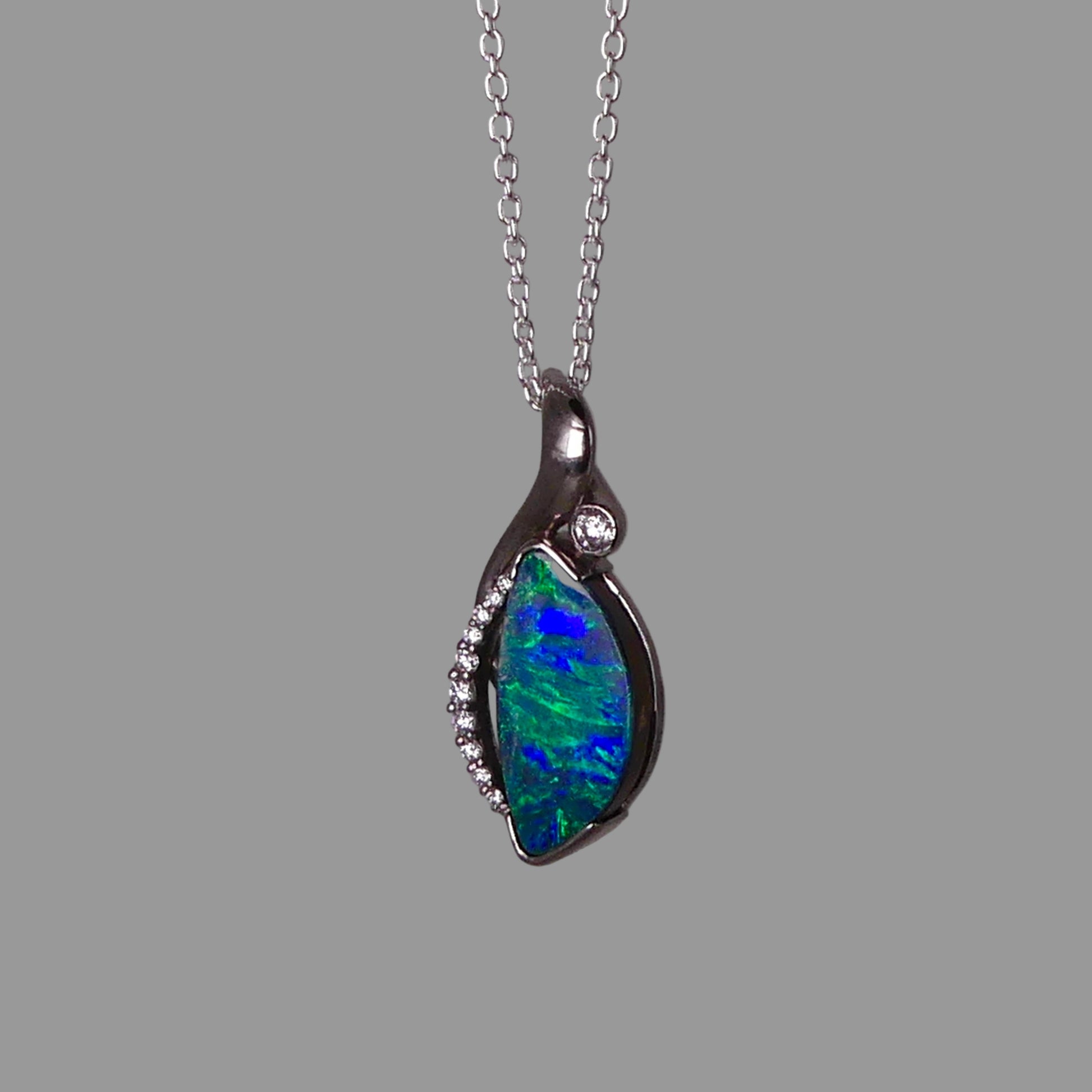 Opal pendant necklace on a gray background