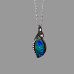 Opal pendant necklace on a gray background