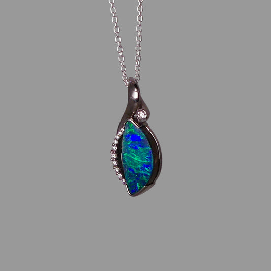 Opal pendant necklace on a gray background