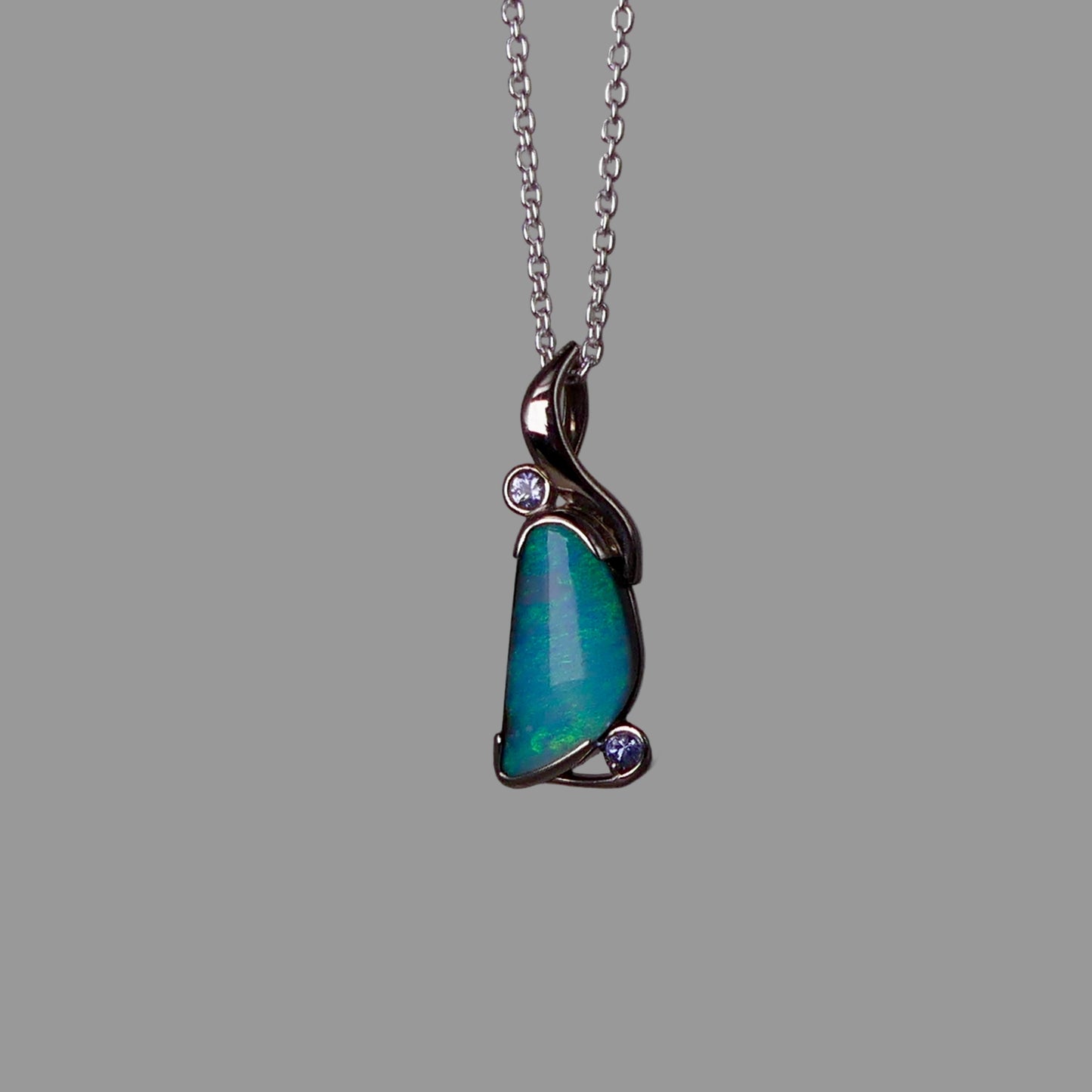 Opal pendant necklace on a gray background