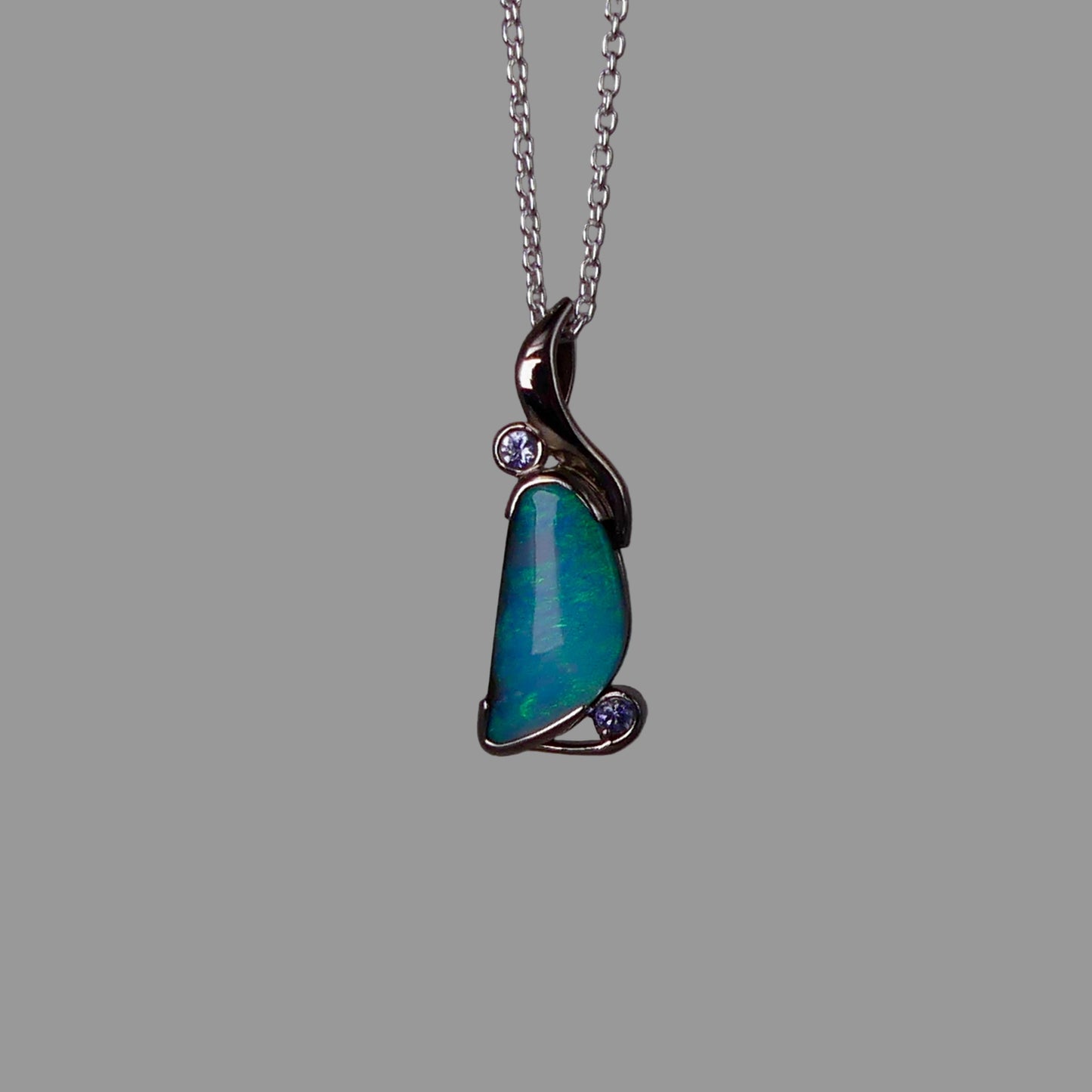 Opal pendant necklace on a gray background