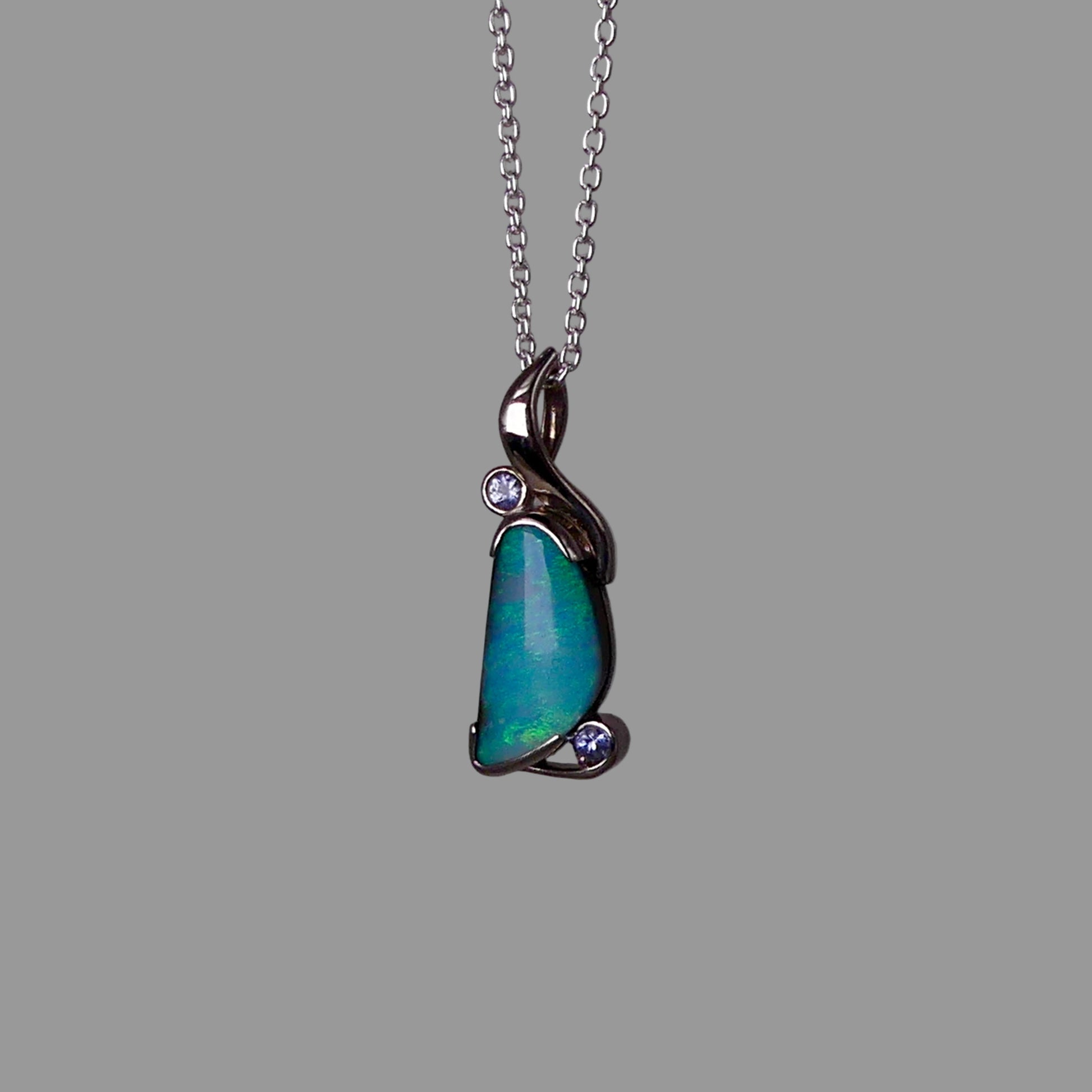 Opal pendant necklace on a gray background