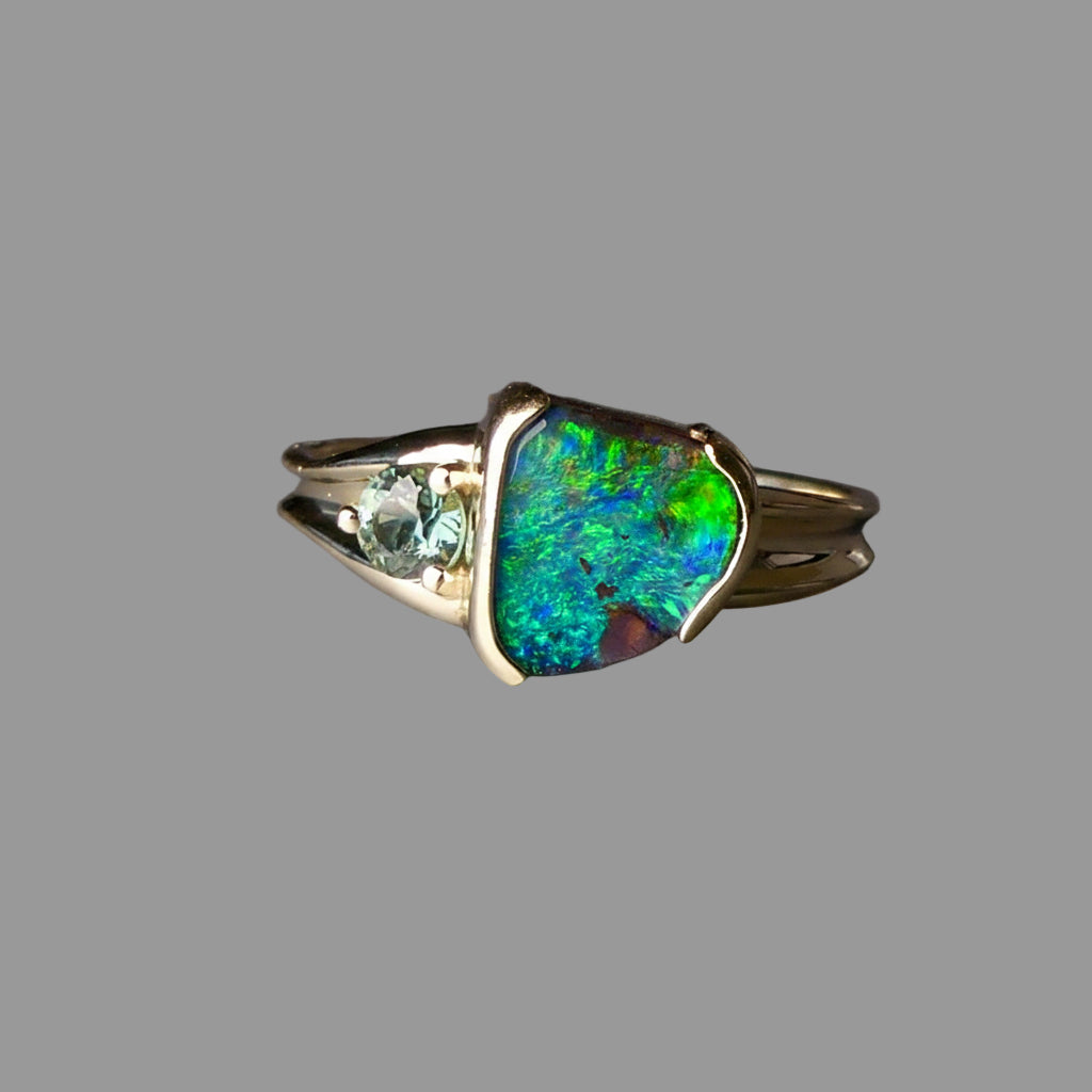 Ring with a colorful gemstone on a gray background