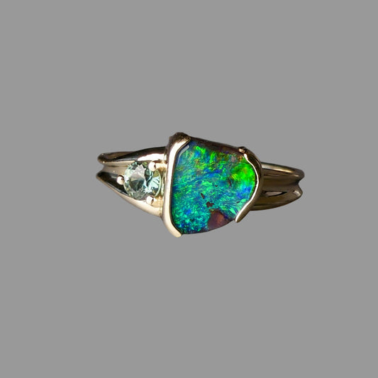 Ring with a colorful gemstone on a gray background