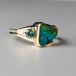 Jewelry with a colorful gemstone and silver setting on a gray background