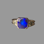 Ring with a blue opal stone on a gray background