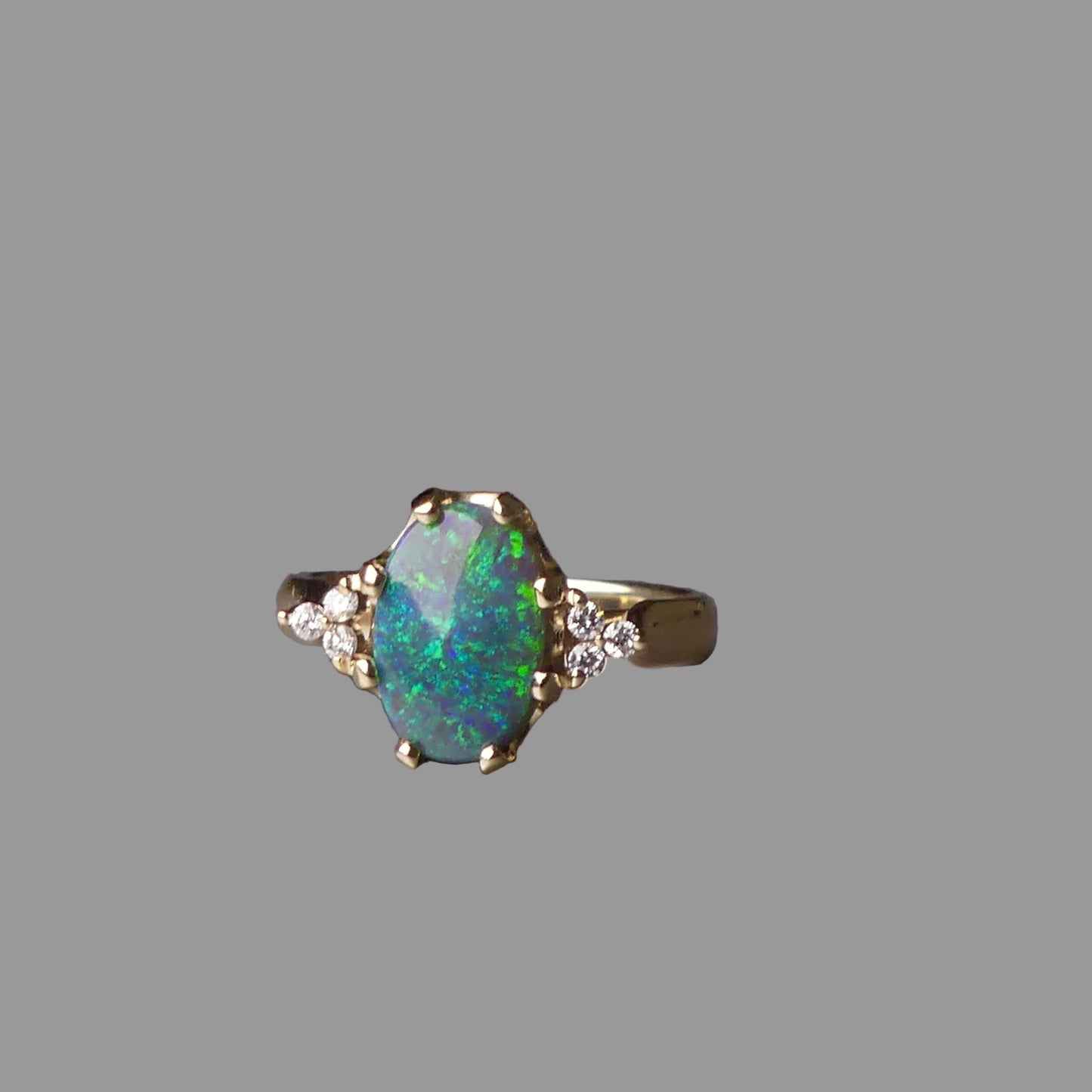 Ring with an opal stone on a gray surface