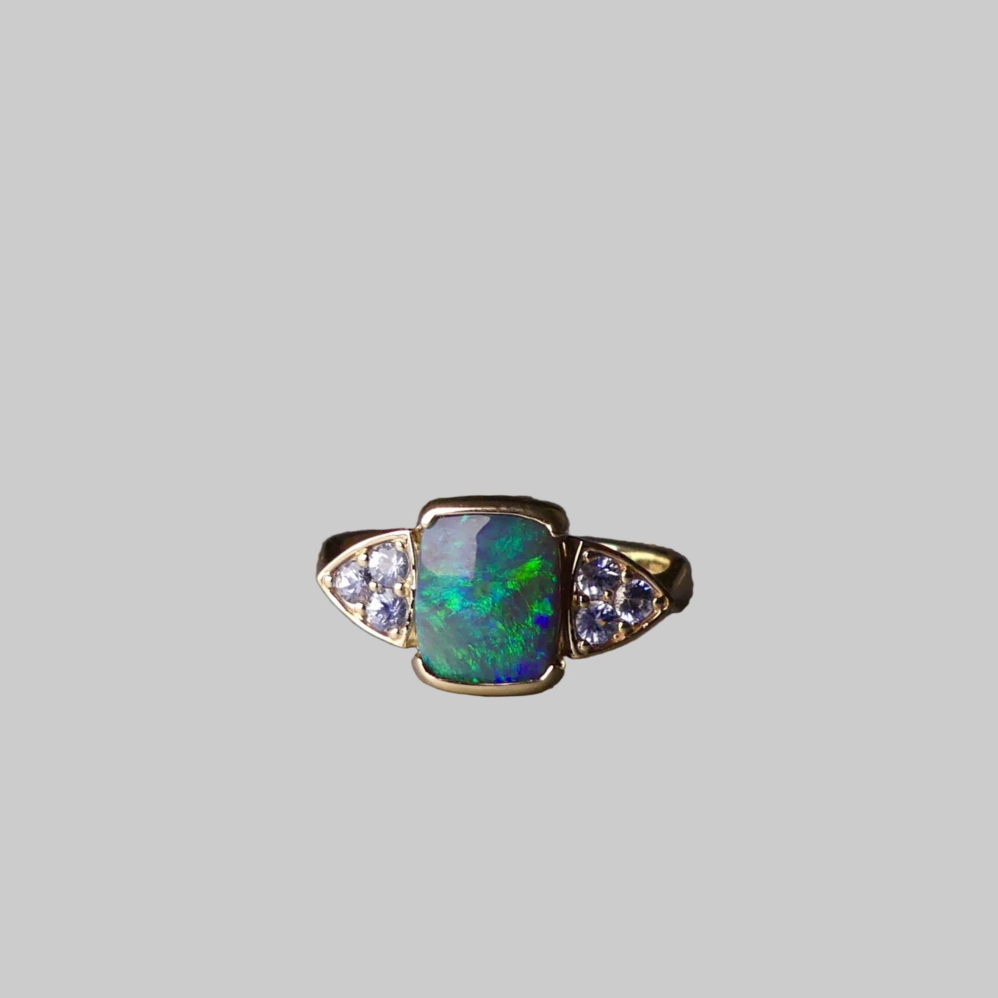 Ring with an opal stone and diamonds on a dark surface