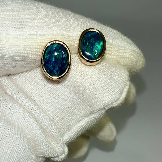 Introducing our exquisite Australian Black Opal Stud Earrings, a captivating fusion of natural beauty and fine craftsmanship. Each earring features a mesmerizing Australian black opal, renowned for its rich play of colors and inherent elegance.

Origin- Lighting Ridge Australia

Opal Weight- Combined weight 2ct Australian Black Opal

Setting- 14k Gold Bezel set Stud Earrings&nbsp;

Size- 10 x 8mm

Designed by Australian Artisans with Elegance and sophistication in mind.