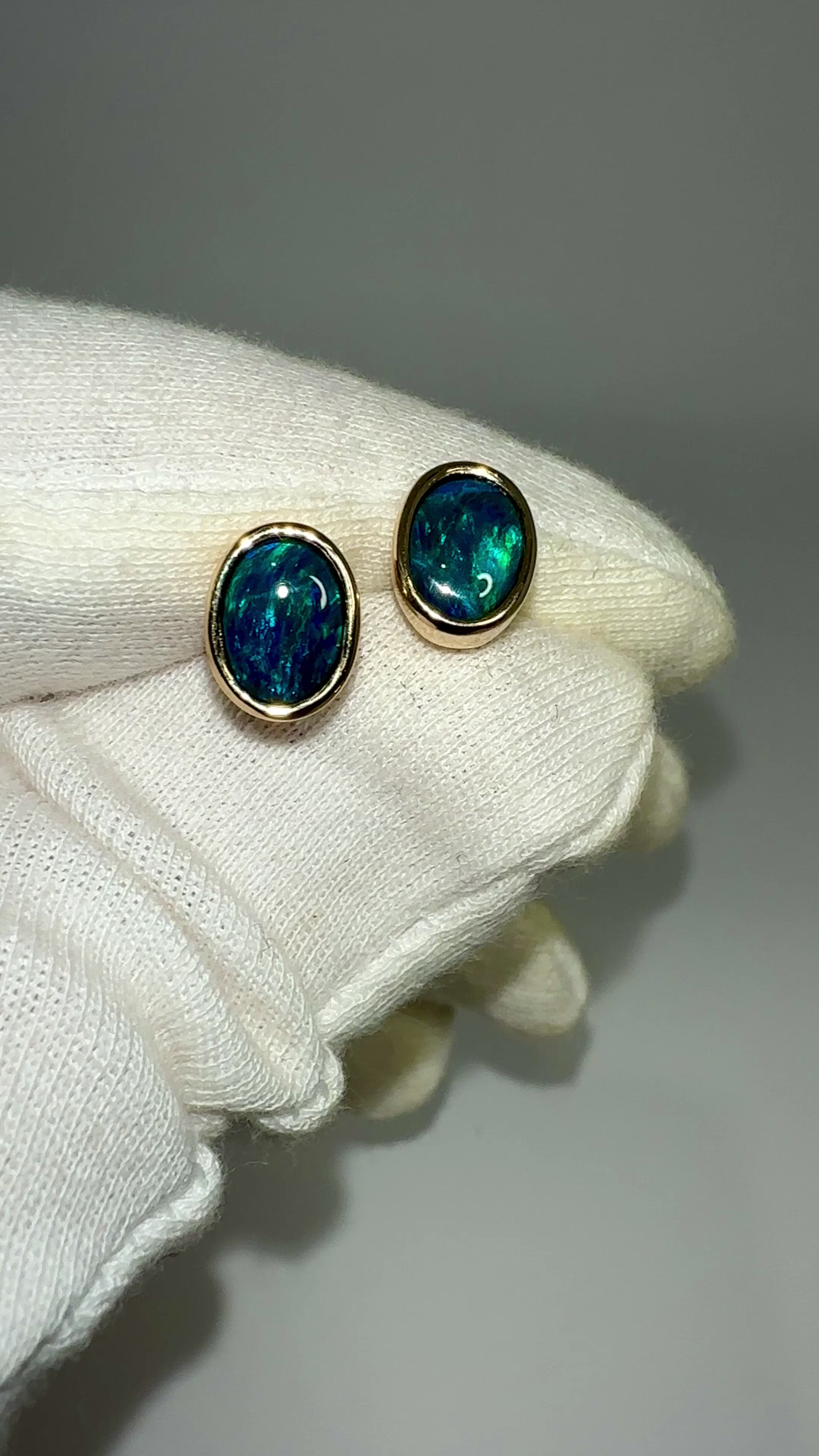 Introducing our exquisite Australian Black Opal Stud Earrings, a captivating fusion of natural beauty and fine craftsmanship. Each earring features a mesmerizing Australian black opal, renowned for its rich play of colors and inherent elegance.

Origin- Lighting Ridge Australia

Opal Weight- Combined weight 2ct Australian Black Opal

Setting- 14k Gold Bezel set Stud Earrings&nbsp;

Size- 10 x 8mm

Designed by Australian Artisans with Elegance and sophistication in mind.