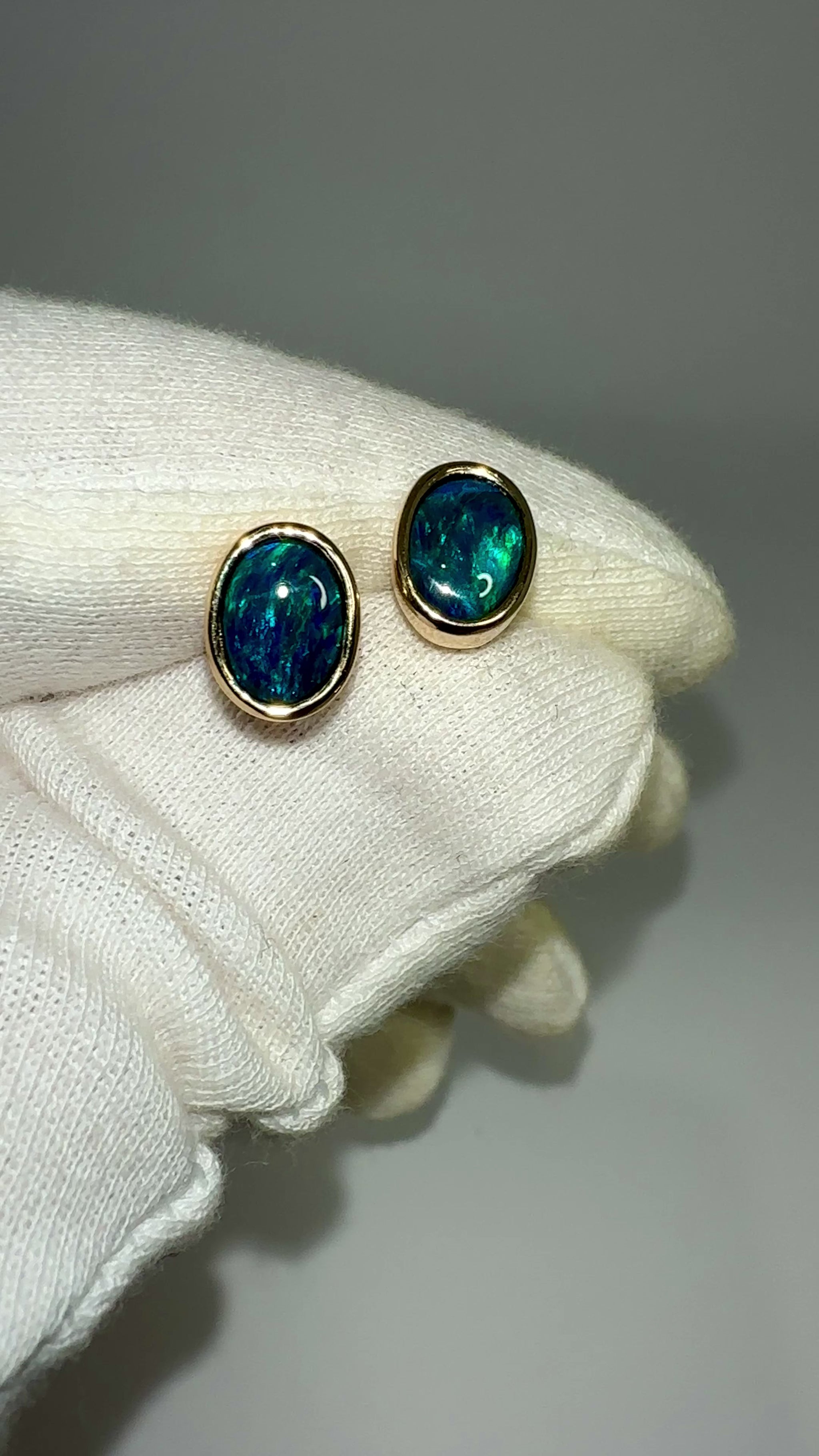 Introducing our exquisite Australian Black Opal Stud Earrings, a captivating fusion of natural beauty and fine craftsmanship. Each earring features a mesmerizing Australian black opal, renowned for its rich play of colors and inherent elegance.

Origin- Lighting Ridge Australia

Opal Weight- Combined weight 2ct Australian Black Opal

Setting- 14k Gold Bezel set Stud Earrings&nbsp;

Size- 10 x 8mm

Designed by Australian Artisans with Elegance and sophistication in mind.