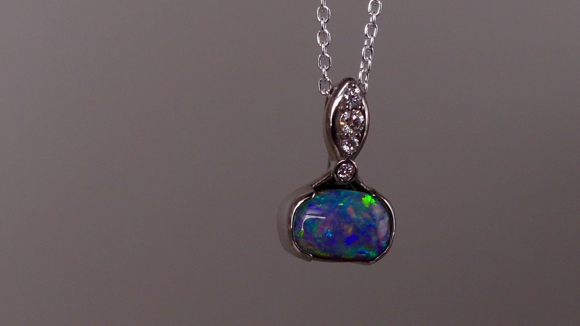 This exquisite pendant features a rare Australian Boulder Opal set in 18k white gold, expertly crafted to highlight the opal’s vibrant play of colors. Accented with natural diamonds, this statement piece that combines exceptional craftsmanship with the distinctive allure of genuine opal.