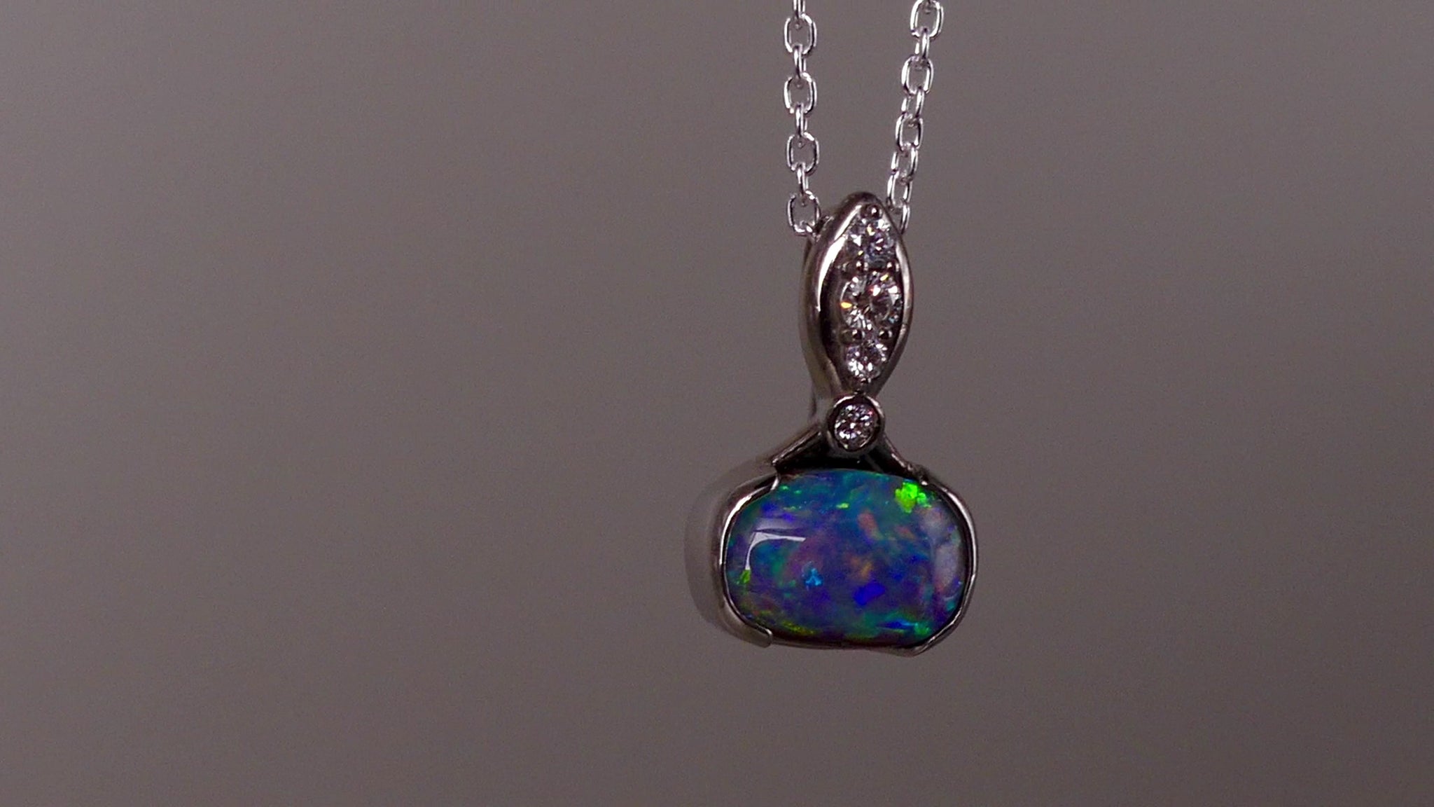 This exquisite pendant features a rare Australian Boulder Opal set in 18k white gold, expertly crafted to highlight the opal’s vibrant play of colors. Accented with natural diamonds, this statement piece that combines exceptional craftsmanship with the distinctive allure of genuine opal.