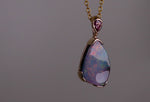 Add a touch of elegance to your jewelry collection with this stunning 9k gold Australian boulder opal pendant. The mesmerizing colors of the opal create a unique and beautiful piece that will surely turn heads. Perfect for everyday wear or special occasions, this pendant is a must-have for any opal lover. A timeless accessory that will elevate any outfit effortlessly.

Opal- 6.75ct Australian Boulder Opal

Origin- Queensland Australia

Setting- 9k Gold Bezel Set

Accent Stone- Pink Sapphire
