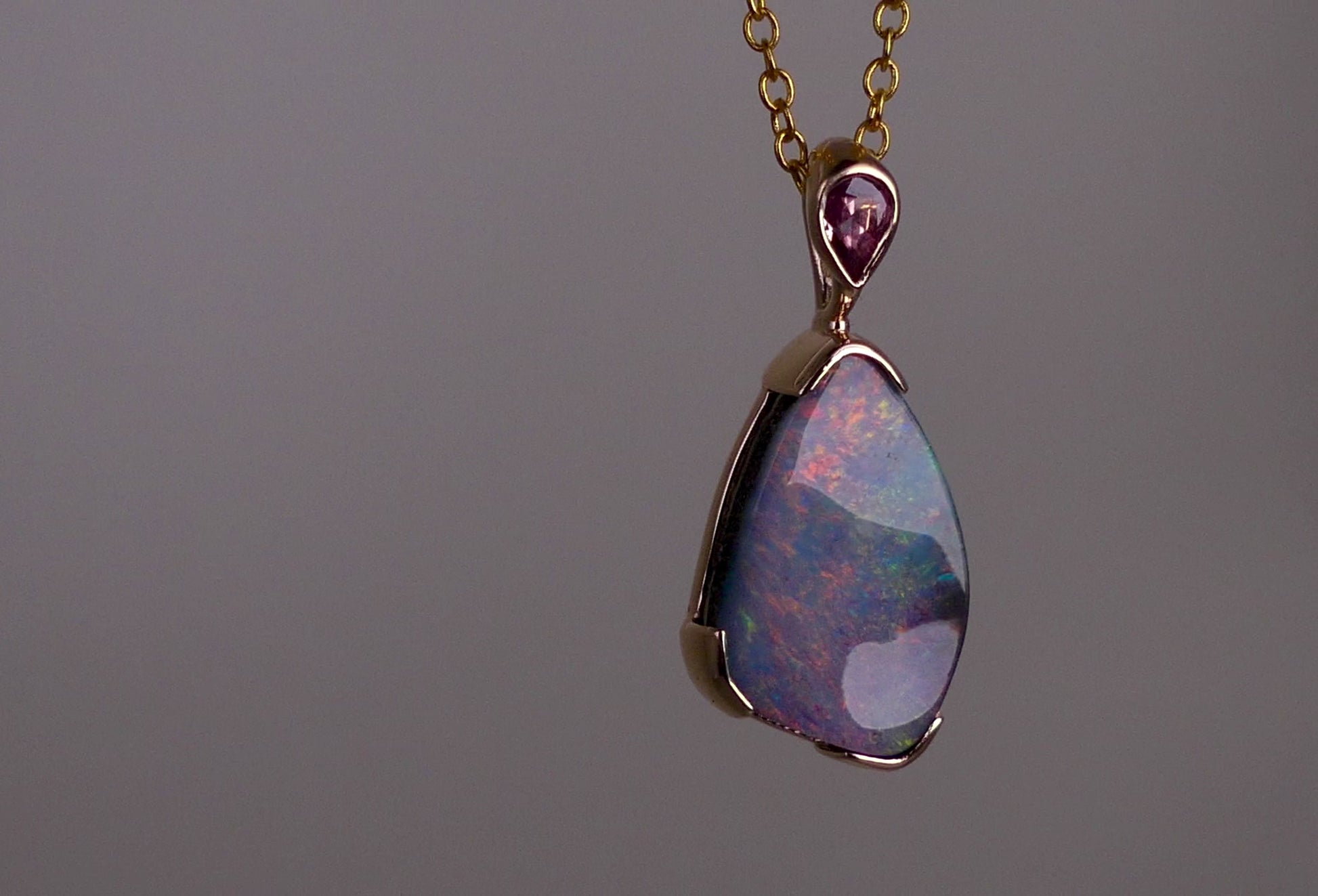 Add a touch of elegance to your jewelry collection with this stunning 9k gold Australian boulder opal pendant. The mesmerizing colors of the opal create a unique and beautiful piece that will surely turn heads. Perfect for everyday wear or special occasions, this pendant is a must-have for any opal lover. A timeless accessory that will elevate any outfit effortlessly.

Opal- 6.75ct Australian Boulder Opal

Origin- Queensland Australia

Setting- 9k Gold Bezel Set

Accent Stone- Pink Sapphire
