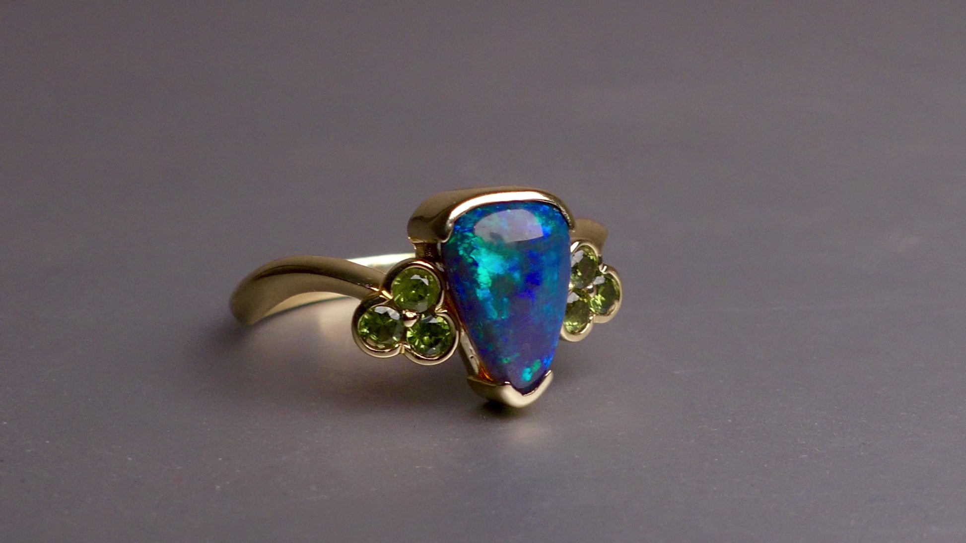 Indulge in timeless elegance with our 14k Australian Black Opal Ring. Crafted with a stunning black opal, this ring showcases mesmerizing blue and green colors. Each piece is unique, making it the perfect addition to any jewelry collection. Elevate your style with this timeless and luxurious ring.

Opal- 1.6ct Australian Black Opal

Origin-Lightning Ridge Australia

Setting- 14k Yellow Gold Bezel Set

Accent Stones- Forrest Green Sapphires

Size- 7 1/4 us
