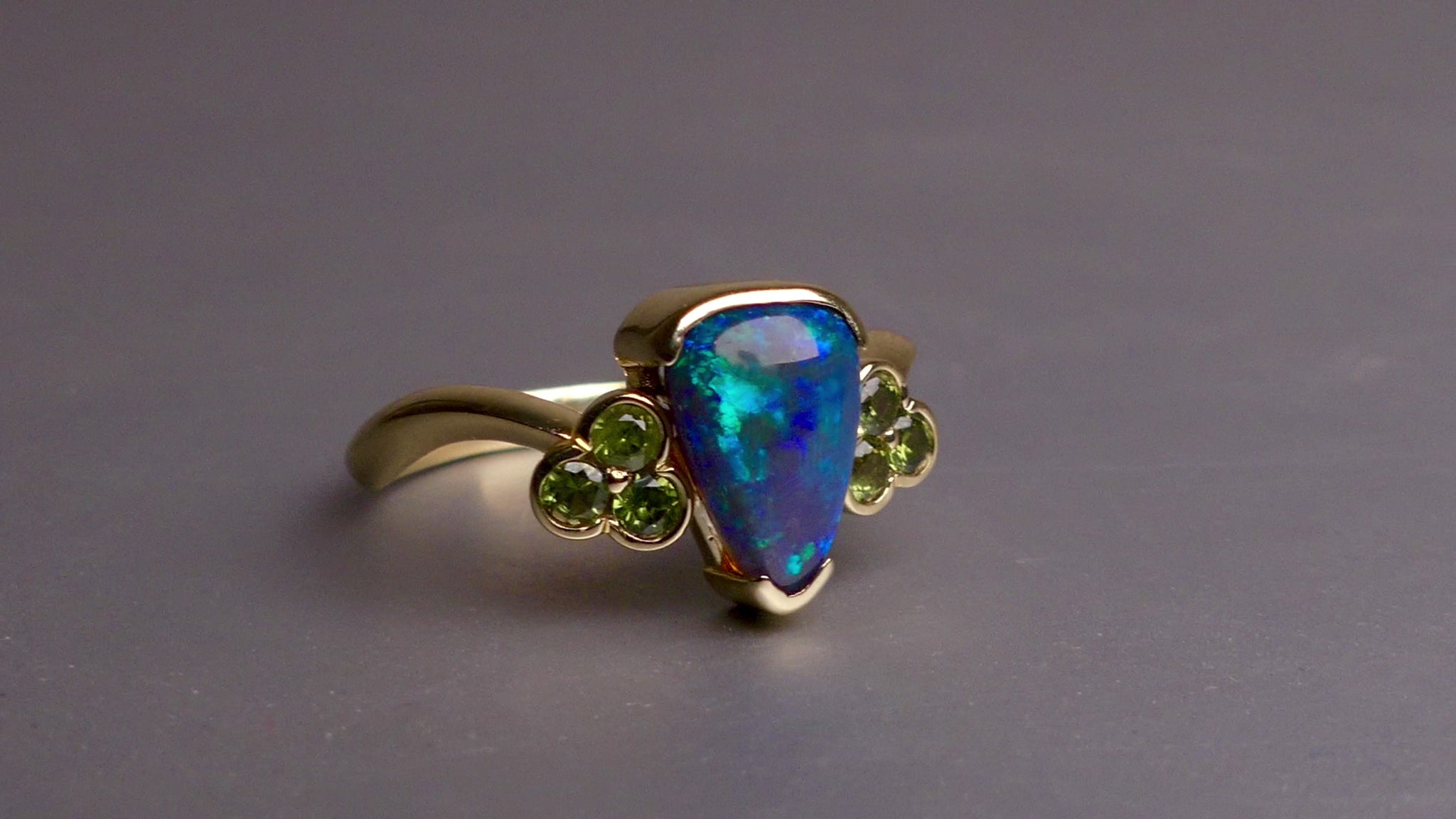 Indulge in timeless elegance with our 14k Australian Black Opal Ring. Crafted with a stunning black opal, this ring showcases mesmerizing blue and green colors. Each piece is unique, making it the perfect addition to any jewelry collection. Elevate your style with this timeless and luxurious ring.

Opal- 1.6ct Australian Black Opal

Origin-Lightning Ridge Australia

Setting- 14k Yellow Gold Bezel Set

Accent Stones- Forrest Green Sapphires

Size- 7 1/4 us
