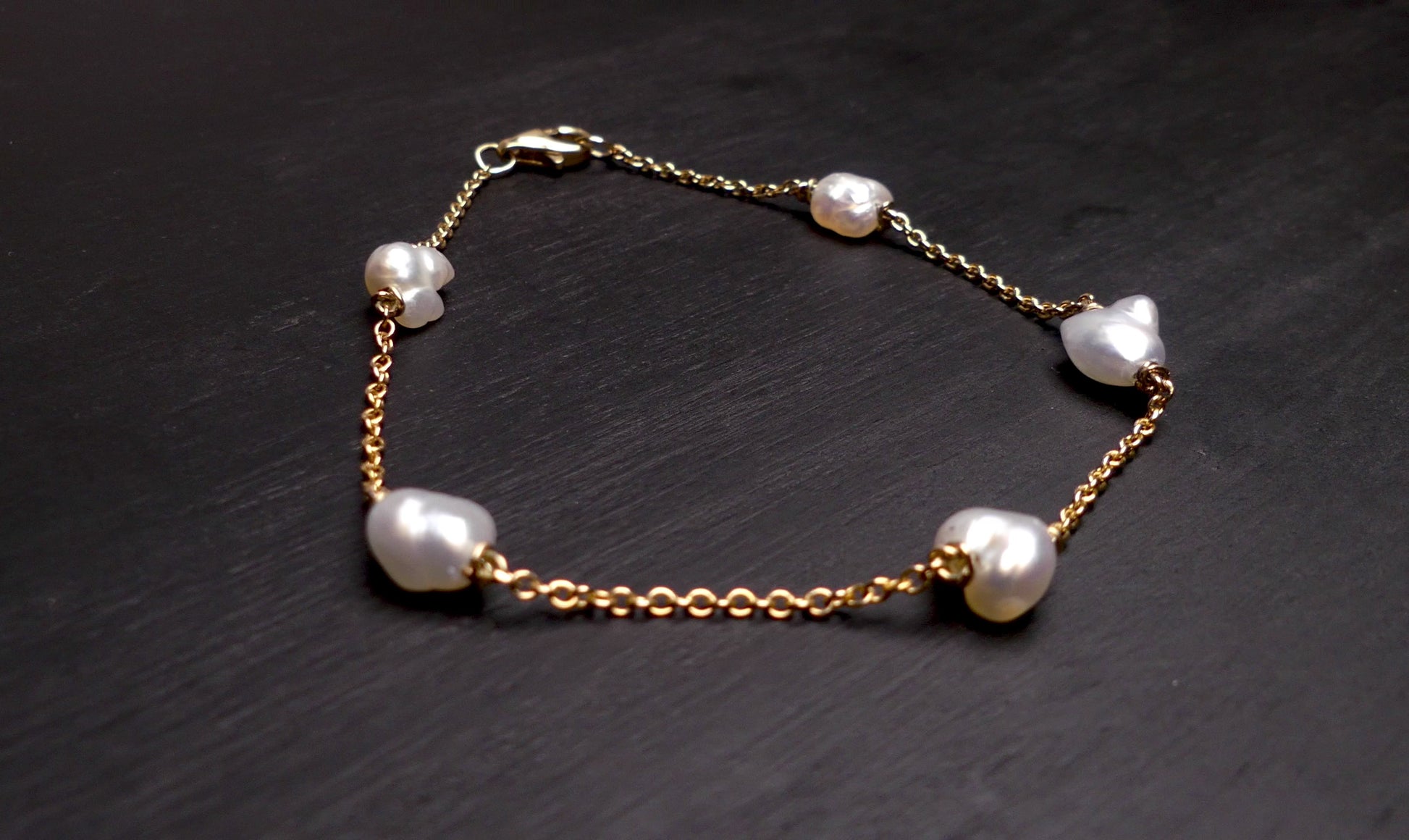 Expertly crafted with 9k gold and 5 Keshi pearls, our Elegant Keshi Pearl Bracelet exudes timeless sophistication. Each pearl's unique shape adds to the overall elegance of the piece, making it a perfect accessory for any occasion. Elevate your style with this exquisite bracelet.

Pearl- Keshi Saltwater Pearls

Setting- Handcrafted 9k Gold

Handcrafted By Australian Artisans