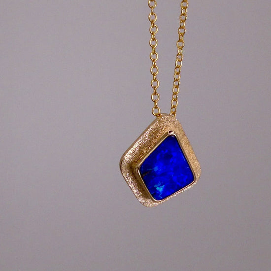 Expertly crafted, this Beautiful Australian Boulder Opal 18k Gold Pendant is a stunning piece of jewelry. Featuring a mesmerizing display of ocean blues and greens, this pendant is complemented by a solid 18k gold chain. Elevate any outfit with this unique and luxurious accessory.

Setting- 18k Gold bezel set

Opal Weight- 4.9ct

Origin- Queensland Australia

Chain- 18k gold cable chan, 45cm in Length

Expertly Handcrafted By Australian Artisans
