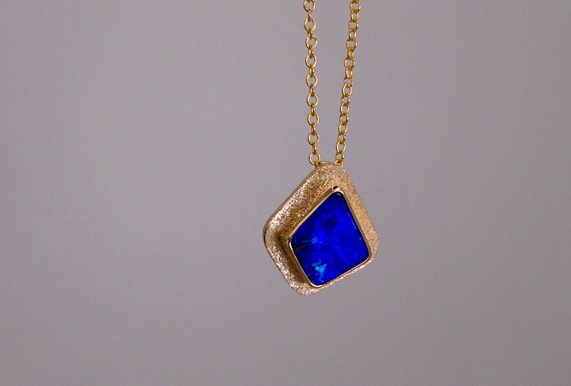 Expertly crafted, this Beautiful Australian Boulder Opal 18k Gold Pendant is a stunning piece of jewelry. Featuring a mesmerizing display of ocean blues and greens, this pendant is complemented by a solid 18k gold chain. Elevate any outfit with this unique and luxurious accessory.

Setting- 18k Gold bezel set

Opal Weight- 4.9ct

Origin- Queensland Australia

Chain- 18k gold cable chan, 45cm in Length

Expertly Handcrafted By Australian Artisans

