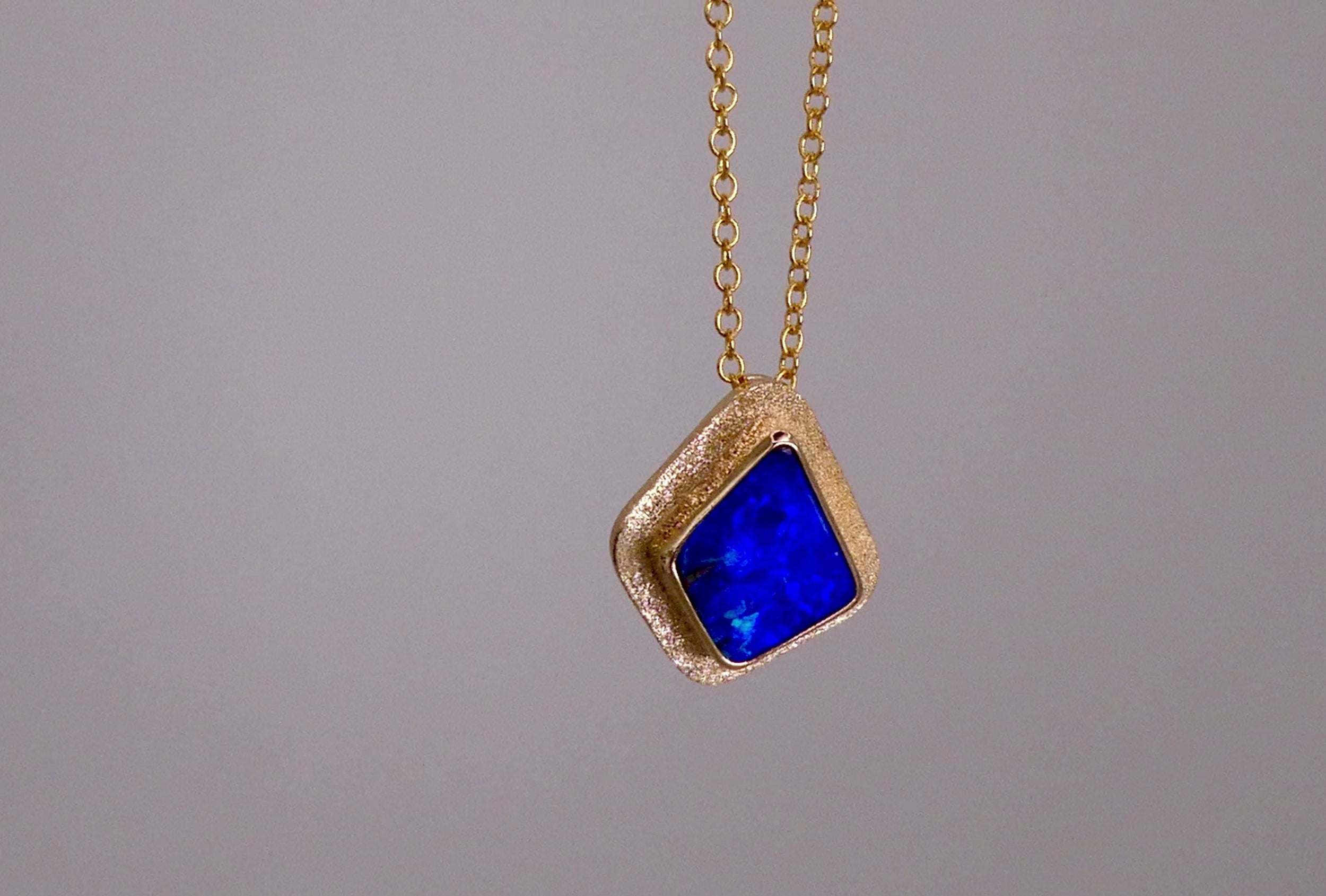 Expertly crafted, this Beautiful Australian Boulder Opal 18k Gold Pendant is a stunning piece of jewelry. Featuring a mesmerizing display of ocean blues and greens, this pendant is complemented by a solid 18k gold chain. Elevate any outfit with this unique and luxurious accessory.

Setting- 18k Gold bezel set

Opal Weight- 4.9ct

Origin- Queensland Australia

Chain- 18k gold cable chan, 45cm in Length

Expertly Handcrafted By Australian Artisans
