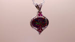 This stunning 18k white gold pendant features a rare and captivating Australian black opal accented with a brilliant center diamond and stunning rubies. Elevate your look with this breathtaking piece and indulge in the unique beauty and elegance of this precious gemstone.

Opal Weight- 1.6ct Australian Black Opal

Opal Origin- Lightning Ridge Australia

Setting- Rhodium Plated 18k White Gold

Accent Stones- Center Diamond, Rubies

Chain- 18k White Gold 45cm in length

