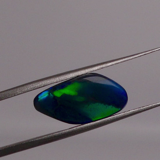 Discover the beauty of the unique 3.5ct Australian Black Opal. With its rare pattern exhibiting stunning blues and greens, this opal is truly one of a kind. Add a touch of rarity and elegance to your collection.

Origin- Lightning Ridge Australlia

Opal Weight- 3.5ct Australian Black Opal

Size- 15.8x8mm

Cut- Freeform cabochon