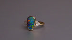 Expertly crafted, this stunning ring features a rare Australian gem boulder opal set in 14k gold and adorned with sparkling diamonds. The unique combination of precious materials and meticulous design makes this ring a one-of-a-kind piece, perfect for any special occasion or as a luxurious addition to any jewelry collection.

Origin- Queensland Australia

Opal Weight- 2.2ct Gem Australian Boulder Opal

Accent Stones- Natural Diamonds

Setting- 14K Gold Bezel Set

Size- 7 1/2 us
