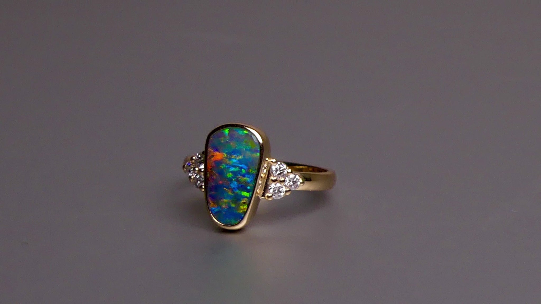 Expertly crafted, this stunning ring features a rare Australian gem boulder opal set in 14k gold and adorned with sparkling diamonds. The unique combination of precious materials and meticulous design makes this ring a one-of-a-kind piece, perfect for any special occasion or as a luxurious addition to any jewelry collection.

Origin- Queensland Australia

Opal Weight- 2.2ct Gem Australian Boulder Opal

Accent Stones- Natural Diamonds

Setting- 14K Gold Bezel Set

Size- 7 1/2 us
