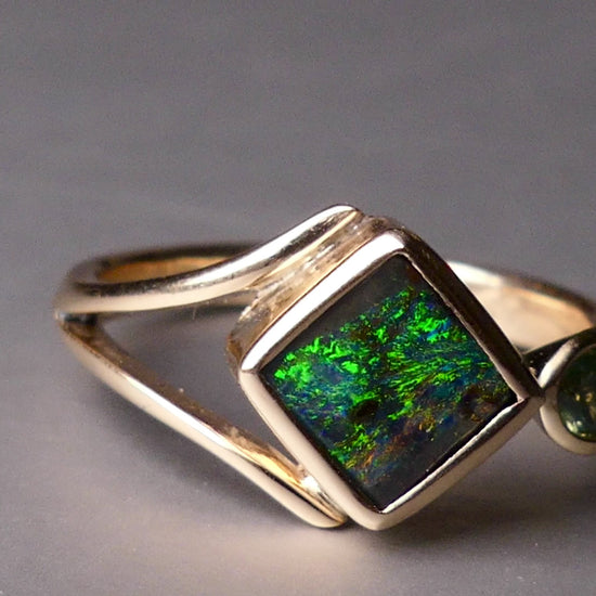 Discover the elegance of this unique 9k gold Australian Boulder Opal ring, beautifully paired with a stunning Australian sapphire. The vibrant opal’s natural patterns and the sapphire’s green blue hues create a captivating contrast, making this ring a true statement piece.