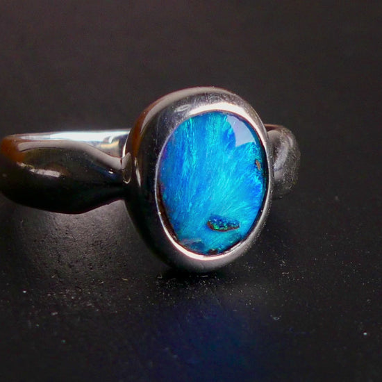 This Vibrant Sterling Silver Boulder Opal Ring showcases stunning ocean blue hues, making it a truly eye-catching accessory. Crafted with high-quality sterling silver and featuring a boulder opal, this ring is both beautiful and durable. Elevate any outfit with this striking piece of jewelry.

Origin- Ethically mined in Queensland Australia

Opal Weight- 1.9ct

Setting- Sterling Silver

Size- 6 1/2us

Crafted By Passionate Australian Artisans