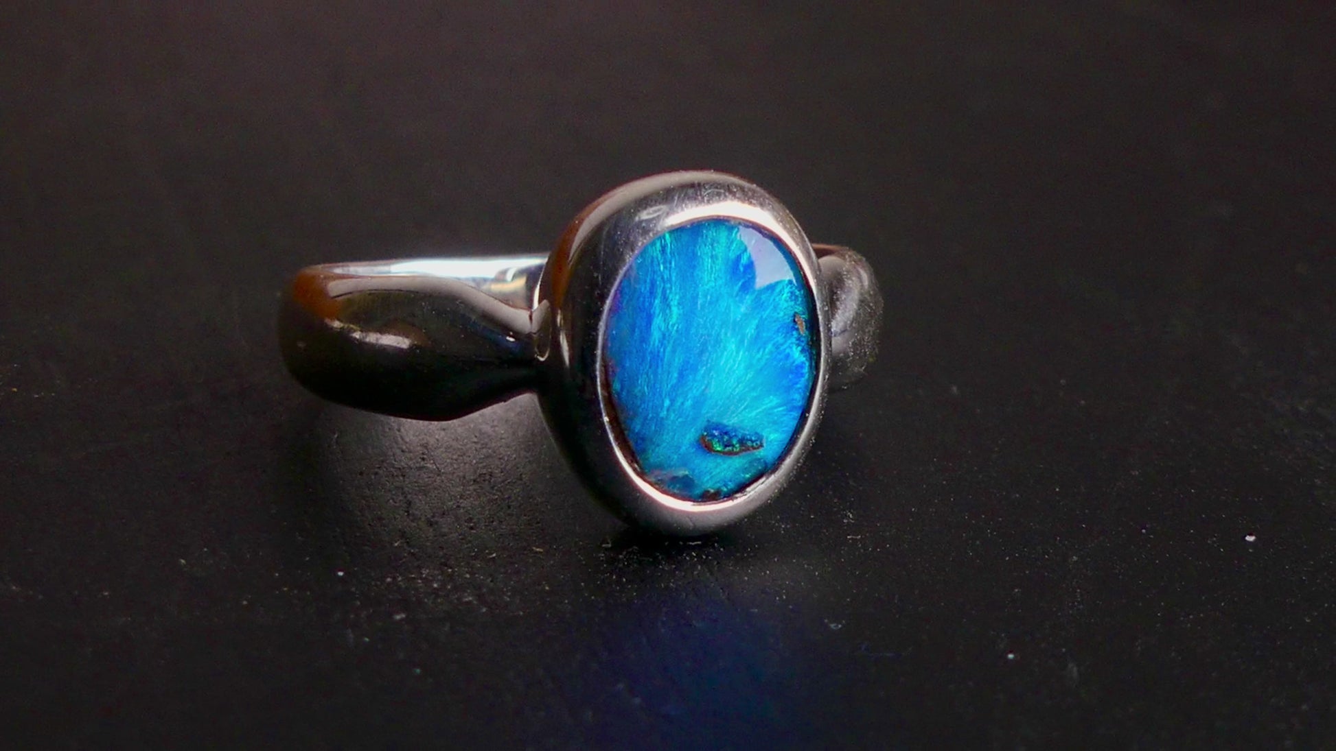 This Vibrant Sterling Silver Boulder Opal Ring showcases stunning ocean blue hues, making it a truly eye-catching accessory. Crafted with high-quality sterling silver and featuring a boulder opal, this ring is both beautiful and durable. Elevate any outfit with this striking piece of jewelry.

Origin- Ethically mined in Queensland Australia

Opal Weight- 1.9ct

Setting- Sterling Silver

Size- 6 1/2us

Crafted By Passionate Australian Artisans