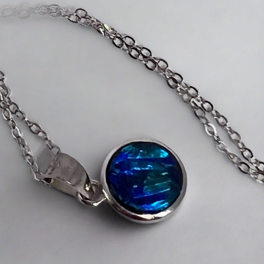 This Australian Sterling Silver Coober Pedy Doublet Pendant is a beautiful piece of jewelry that features a Coober Pedy doublet opal.

Origin- Coober Pedy Australia Opal Doublet

Setting- Sterling Silver Bezel set

Chain- Sterling Silver cable, 45cm in length
